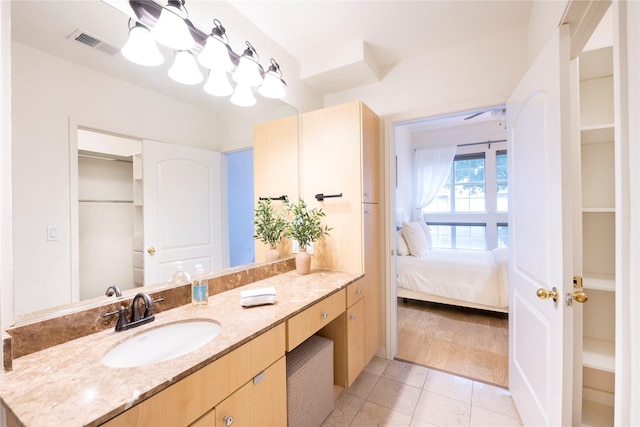 bathroom with vanity, ensuite bathroom, and a chandelier