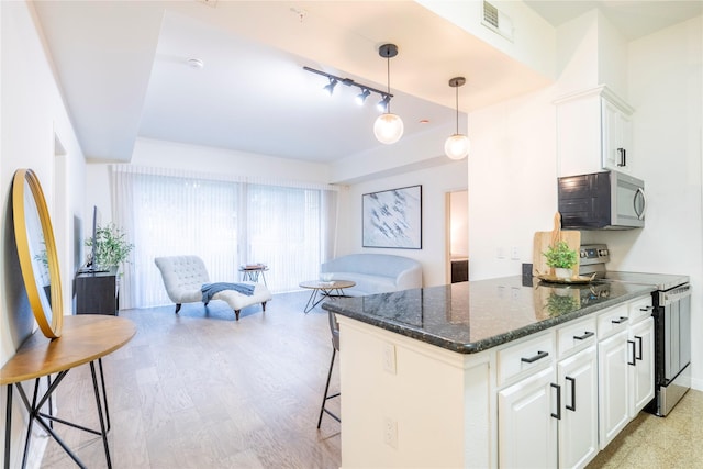 kitchen featuring stainless steel electric range, white cabinets, track lighting, dark stone countertops, and light wood-style floors