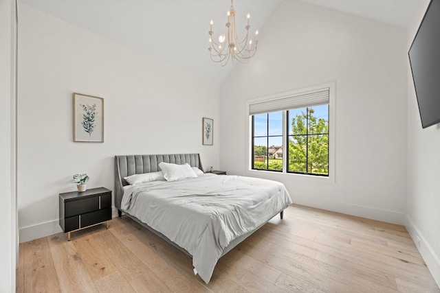 bedroom featuring light wood-style flooring, baseboards, high vaulted ceiling, and a chandelier