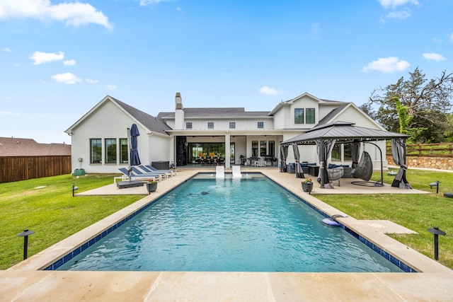 back of house featuring a patio area, a fenced backyard, a gazebo, and a yard