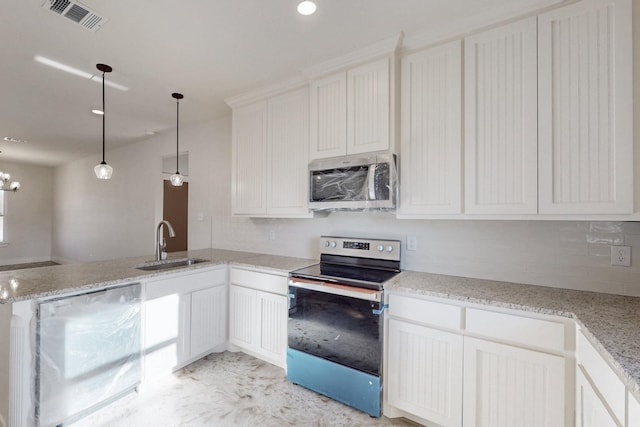 kitchen featuring stainless steel appliances, a sink, a peninsula, white cabinetry, and hanging light fixtures