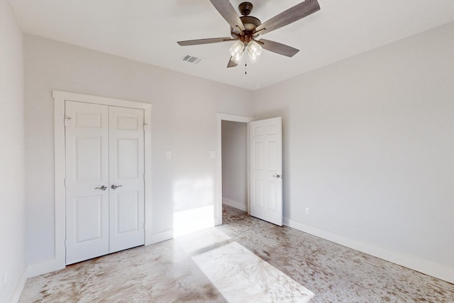 unfurnished bedroom with a closet, baseboards, and ceiling fan