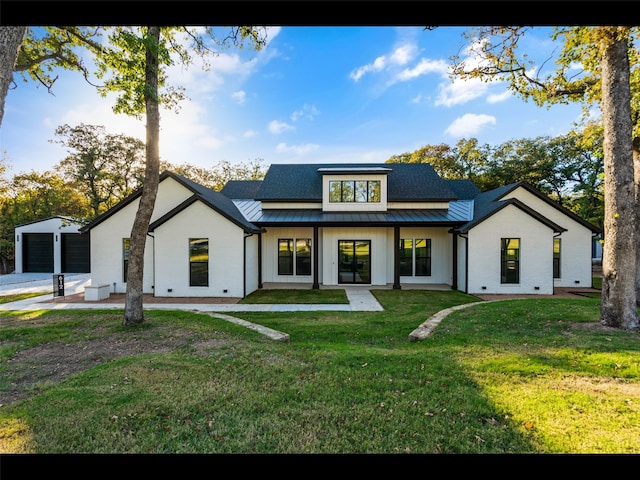 612 Glade Stream Ct, Azle, TX 76020 - rear view of house with metal roof, a standing seam roof, a lawn, brick siding, and a garage