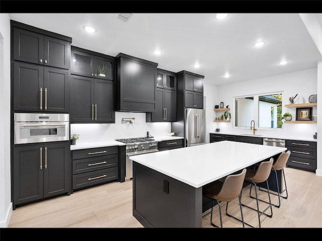 612 Glade Stream Ct, Azle, TX 76020 - kitchen with premium appliances, open shelves, a sink, light wood-style floors, and a kitchen bar