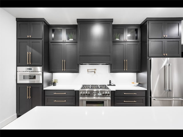 612 Glade Stream Ct, Azle, TX 76020 - kitchen with glass insert cabinets, light countertops, high end appliances, and exhaust hood