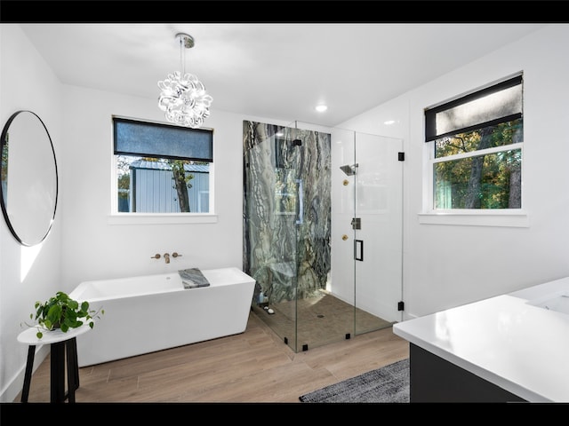 612 Glade Stream Ct, Azle, TX 76020 - bathroom featuring a freestanding bath, an inviting chandelier, wood finished floors, and a marble finish shower