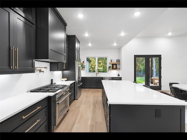 612 Glade Stream Ct, Azle, TX 76020 - kitchen featuring a center island, premium appliances, a sink, light wood finished floors, and light countertops