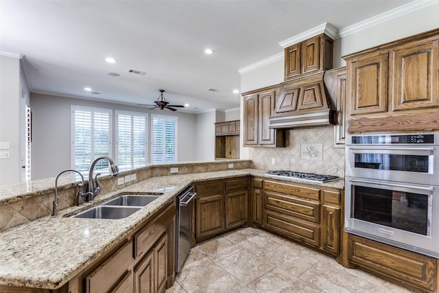kitchen with a sink, appliances with stainless steel finishes, tasteful backsplash, ornamental molding, and light stone countertops