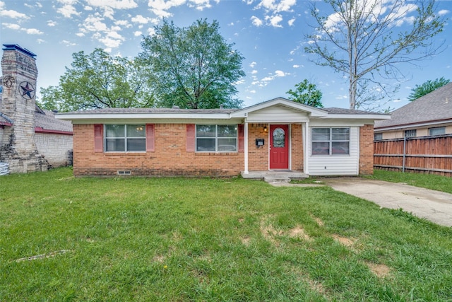 ranch-style home with fence, brick siding, and a front yard