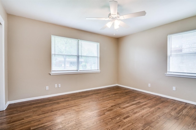 unfurnished room with wood finished floors, baseboards, and ceiling fan