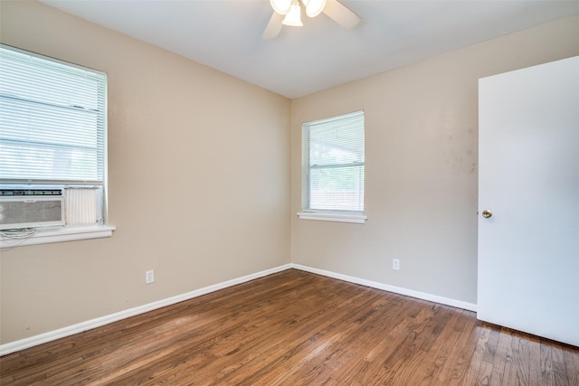 spare room with cooling unit, wood finished floors, baseboards, and ceiling fan