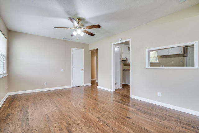 interior space with visible vents, wood finished floors, and baseboards