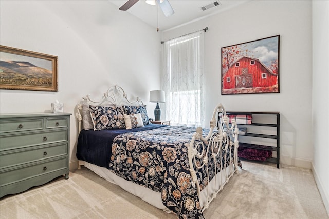 bedroom with baseboards, visible vents, light colored carpet, and ceiling fan