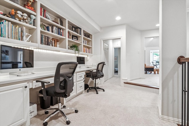 office area with built in desk, recessed lighting, and light colored carpet