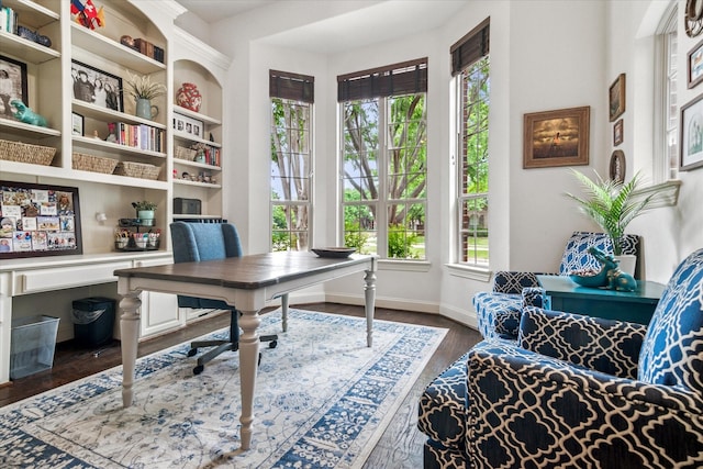 office space with baseboards and dark wood-type flooring