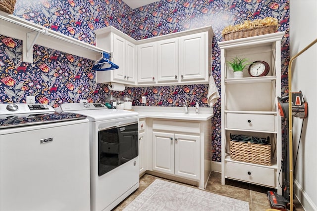 laundry room with a sink, cabinet space, light tile patterned flooring, washer and dryer, and wallpapered walls