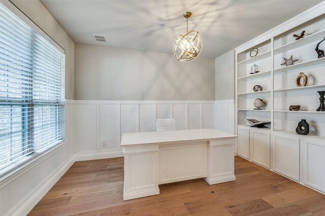 unfurnished dining area with plenty of natural light, visible vents, and light wood finished floors