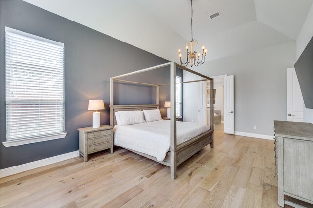 bedroom with light wood finished floors, baseboards, a notable chandelier, and multiple windows