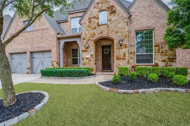 view of front of property featuring a front lawn, brick siding, roof with shingles, and stone siding