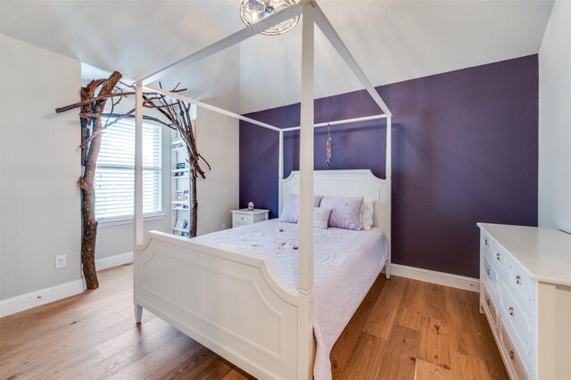 bedroom with baseboards and light wood-style floors