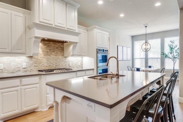 kitchen with recessed lighting, light wood-style floors, tasteful backsplash, and stainless steel appliances