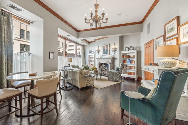 living area with a fireplace, visible vents, an inviting chandelier, and a healthy amount of sunlight