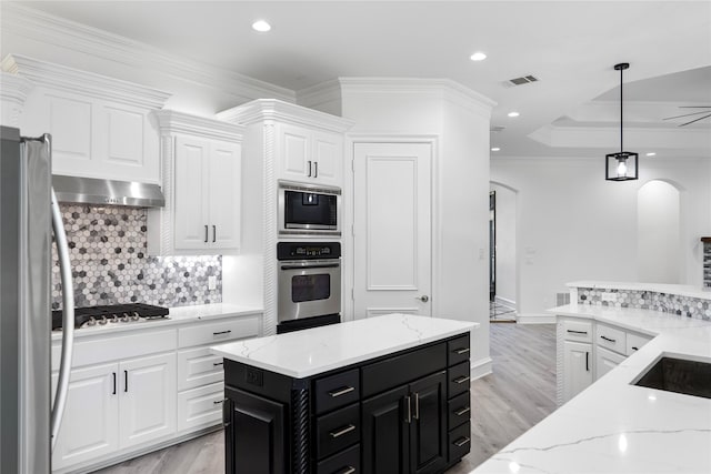 422 Mustang Dr, Sunnyvale, TX 75182 - kitchen featuring stainless steel appliances, dark cabinetry, arched walkways, white cabinets, and recessed lighting