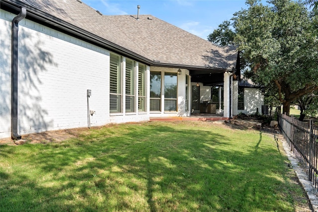 422 Mustang Dr, Sunnyvale, TX 75182 - rear view of house with a shingled roof, brick siding, and a patio