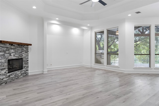 422 Mustang Dr, Sunnyvale, TX 75182 - unfurnished living room with crown molding, healthy amount of natural light, ceiling fan, a stone fireplace, and a tray ceiling