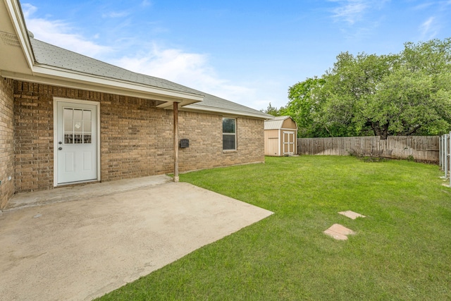 view of yard featuring a fenced backyard, a patio area, a storage shed, and an outbuilding