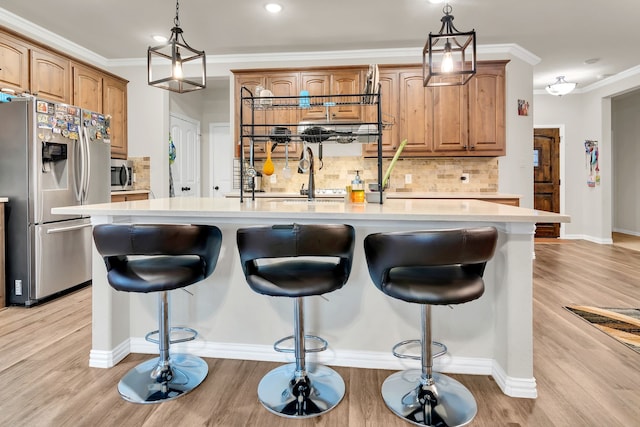 1728 Rio Secco Dr, Fort Worth, TX 76131 - kitchen featuring stainless steel appliances, light countertops, a center island with sink, decorative backsplash, and light wood-style flooring
