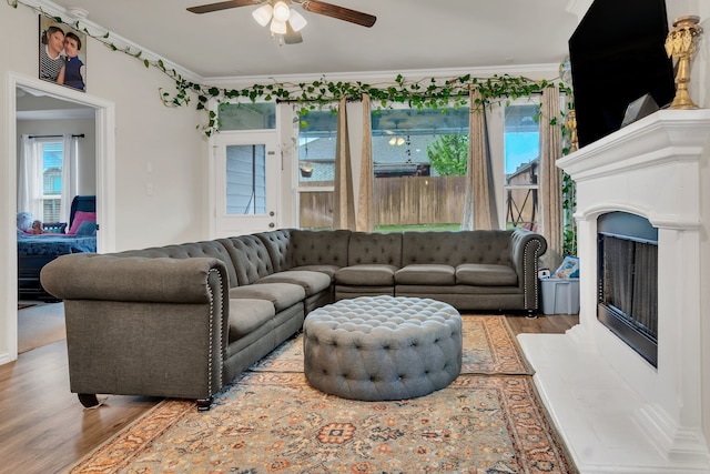 1728 Rio Secco Dr, Fort Worth, TX 76131 - living area with ornamental molding, wood finished floors, a fireplace with raised hearth, and ceiling fan