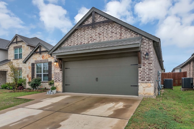 1728 Rio Secco Dr, Fort Worth, TX 76131 - craftsman inspired home featuring stone siding, fence, cooling unit, and a garage