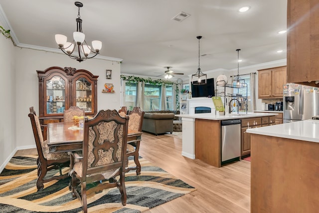 1728 Rio Secco Dr, Fort Worth, TX 76131 - dining room with light wood finished floors, ceiling fan with notable chandelier, visible vents, and crown molding