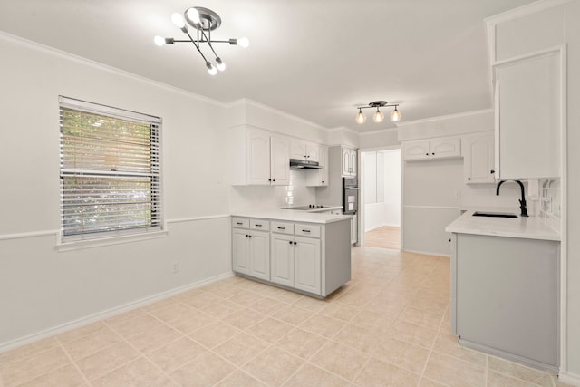 kitchen featuring a sink, crown molding, light countertops, and white cabinets