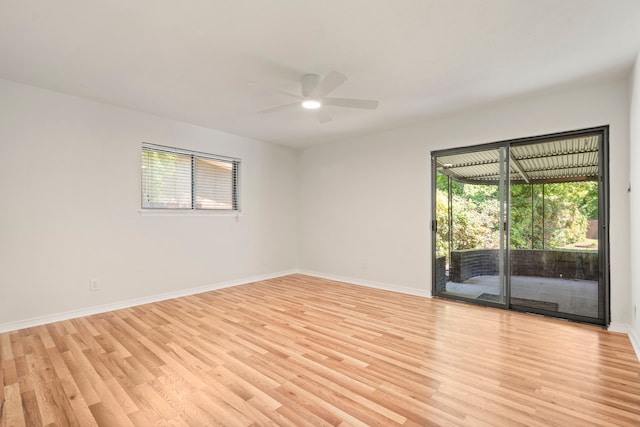 empty room with baseboards, light wood-style flooring, and ceiling fan