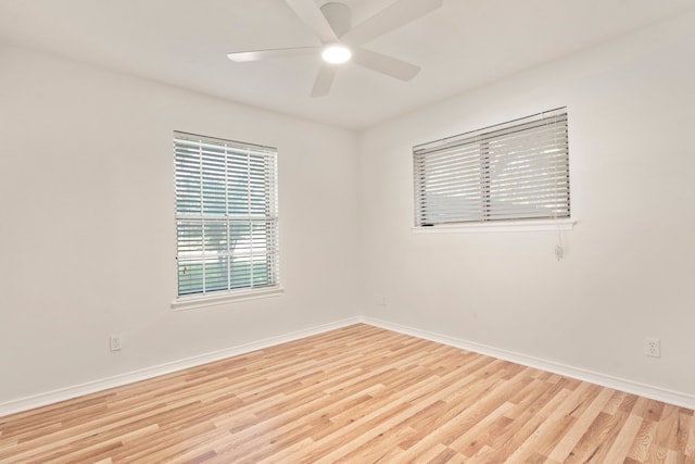 spare room featuring a ceiling fan, wood finished floors, and baseboards