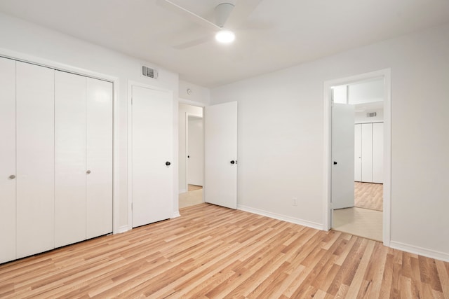 unfurnished bedroom featuring a ceiling fan, a closet, baseboards, visible vents, and light wood-style floors