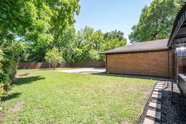 view of yard with a fenced backyard
