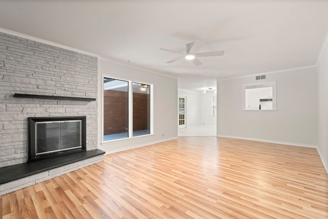 unfurnished living room with ceiling fan, ornamental molding, visible vents, and wood finished floors
