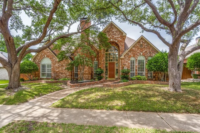 1405 Chesapeake Dr, Plano, TX 75093 - traditional-style home with brick siding, a front lawn, and a chimney