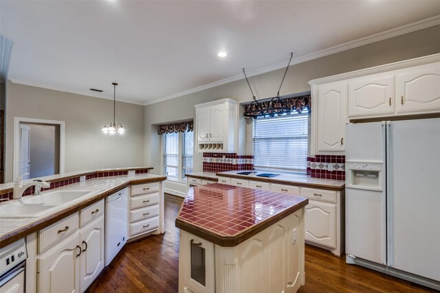 1405 Chesapeake Dr, Plano, TX 75093 - kitchen featuring white appliances, a sink, dark wood-style floors, tasteful backsplash, and white cabinets