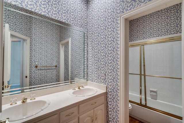 1405 Chesapeake Dr, Plano, TX 75093 - full bath with wallpapered walls, toilet, double vanity, and combined bath / shower with glass door
