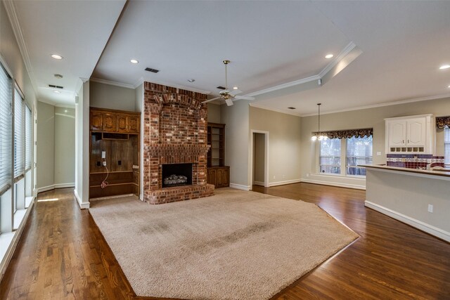 1405 Chesapeake Dr, Plano, TX 75093 - unfurnished living room featuring ceiling fan, dark wood-style floors, a brick fireplace, ornamental molding, and recessed lighting