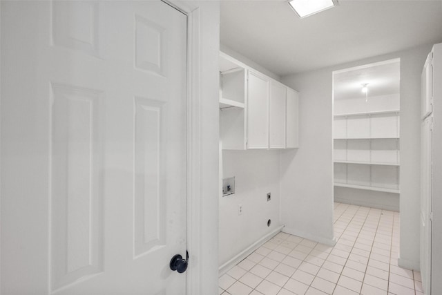 3319 Sheffield Dr, Arlington, TX 76013 - laundry area with hookup for an electric dryer, hookup for a washing machine, cabinet space, light tile patterned floors, and baseboards