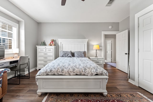 bedroom with dark wood-style floors, visible vents, ceiling fan, and baseboards