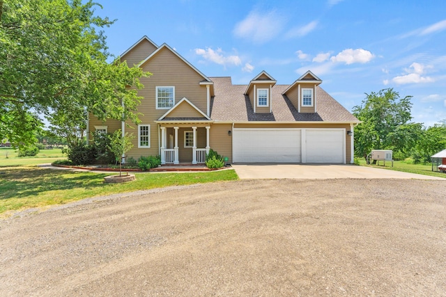 view of front of property with a front lawn, a shingled roof, covered porch, driveway, and an attached garage