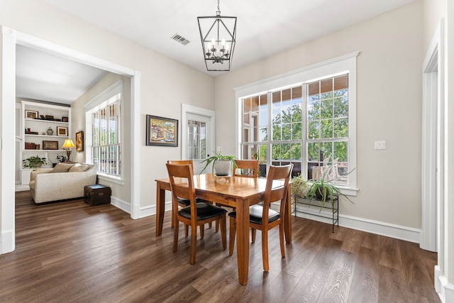 dining area with an inviting chandelier, wood finished floors, and stairs