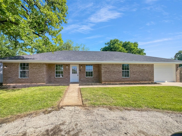 316 W 3rd Ter, Springtown, TX 76082 - single story home with brick siding, a front lawn, concrete driveway, and an attached garage