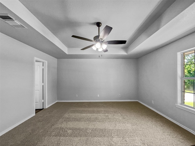 316 W 3rd Ter, Springtown, TX 76082 - carpeted empty room featuring visible vents, ceiling fan, a tray ceiling, and baseboards